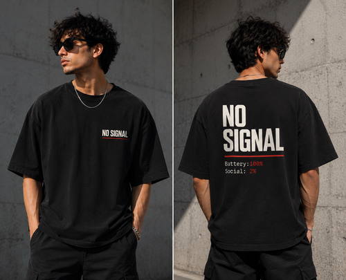 A man modeling a black oversized T-shirt in a split front-and-back view against a concrete wall. The front shows a small white 'NO SIGNAL' chest print, and the back shows a large white 'NO SIGNAL' graphic with small red text reading 'Battery: 100%' and 'Social: 2%'.